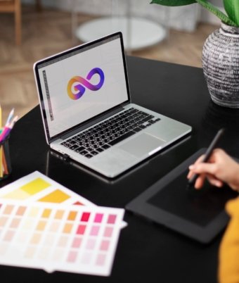 female-logo-designer-working-her-tablet-connected-laptop
